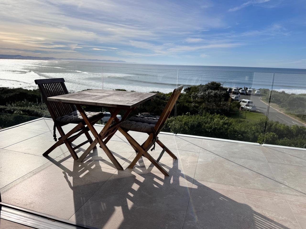 Private terrace with table and chairs overlooking the ocean